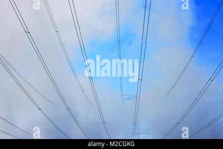 High voltage power lines on foggy morning. Stock Photo