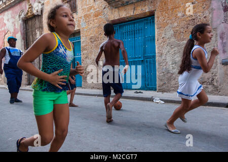Cuban children playing football or soccer in the street. Havana, Cuba. Stock Photo