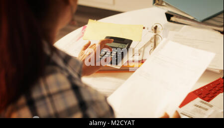 Old people, tax return and home banking. Senior woman paying federal taxes, doing family budget. Elderly person typing on calculator. Concept of money Stock Photo