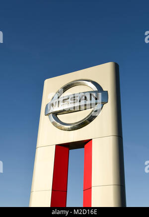 A large sign outside a Nissan car dealership Stock Photo