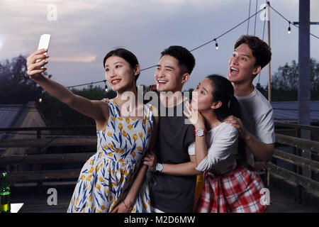 Young people take pictures with their cell phones Stock Photo