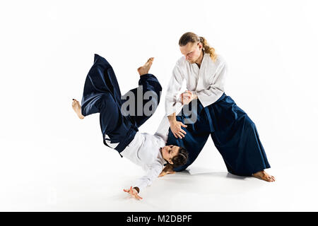 Man and woman fighting at Aikido training in martial arts school Stock Photo