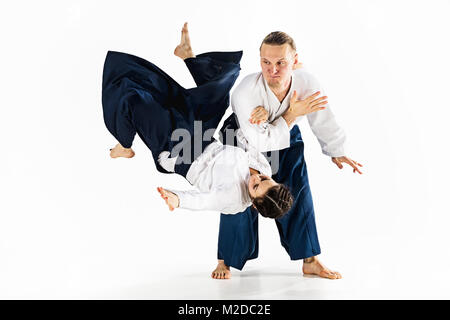 Man and woman fighting at Aikido training in martial arts school Stock Photo