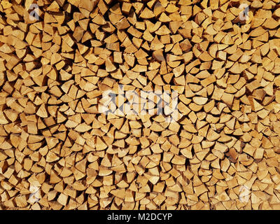 Cut and stacked a lot of firewood pieces as background. Stock Photo