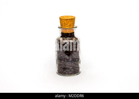 Roasted coffee beans in a glass jar with cork on a white background Stock Photo