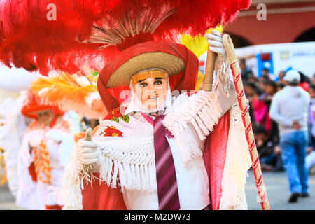 Horizontal photo of a Carnival scene, a dancer wearing a traditional mexican folk costume and mask rich in color Stock Photo