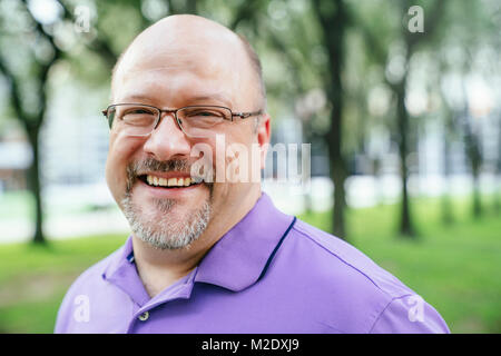 Portrait of laughing Caucasian man in park Stock Photo