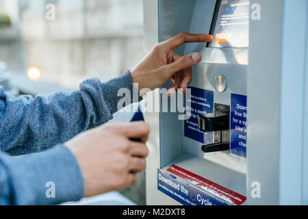 Hands of Black man paying at kiosk with credit card Stock Photo