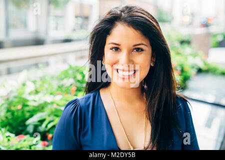 Close up portrait of smiling Hispanic woman Stock Photo