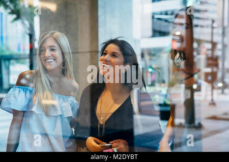 Smiling women window shopping Stock Photo