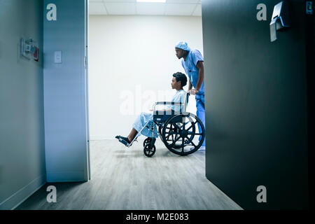 Nurse pushing boy in wheelchair Stock Photo