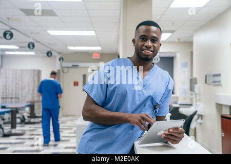 Portrait of smiling doctor using digital tablet in hospital Stock Photo