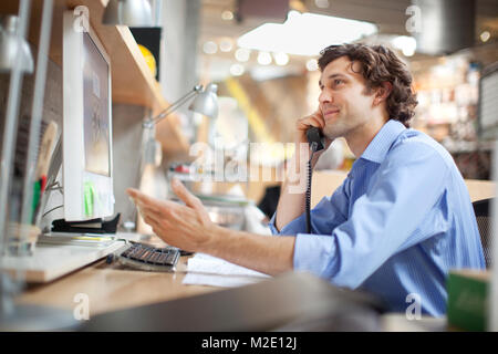 Hispanic businessman talking on telephone Stock Photo