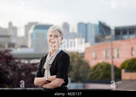 Portrait of pensive Caucasian businesswoman posing outdoors Stock Photo