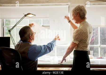 Architects examining blueprint in office Stock Photo