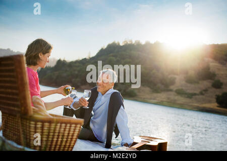 Couple enjoying wine at waterfront Stock Photo