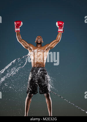 Water splashing on winning Black boxer Stock Photo