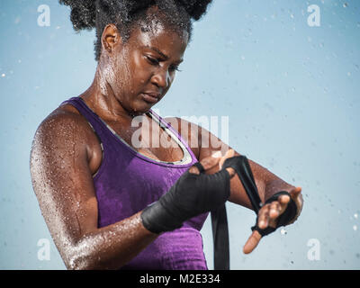 Sweating Black boxer wrapping hands Stock Photo