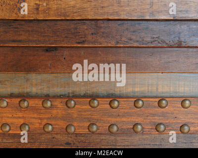 Dark brown vintage wooden stripped background with brass buttons Stock Photo