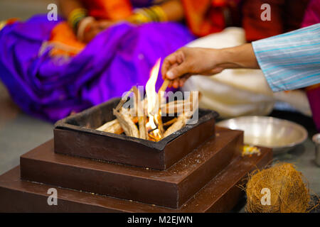 It is offerings to all the invisible Gods with the help of fire as the fire flames rise upward they seem to get those offerings reach heavenly gods. Stock Photo