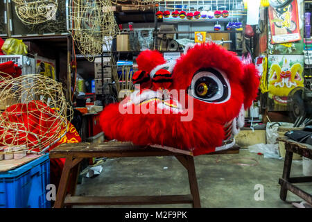 SUBANG, MALAYSIA - FEBRUARY 07: A traditional Chinese Lion head is seen inside the Wan Seng Hang (WSH) Dragon & Lion Arts workshop in Subang outside Kuala Lumpur on February 7, 2018. WSH produce around 500 lion heads per year with some being exported to Asia including Taiwan, Japan, Hong Kong, United States and around the world. The traditional Lion Head certain combinations of colour and design were created as a tribute to famous Chinese historical, entire process is done by hand and rattan is used to form the skeletal structure of the head with layers of bamboo paper. The price of a complete Stock Photo