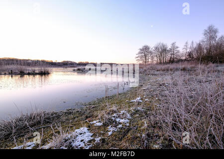Preston UK. 7th February 2018. UK Weather. It was a bright but cold start to the day in Lancashire with temperatures below zero first thing. The 'lakes' at Brockholes Nature Reserve started to ice over before the sun rose and the temperatures rose slightly. Credit: Paul Melling/Alamy Live News Stock Photo