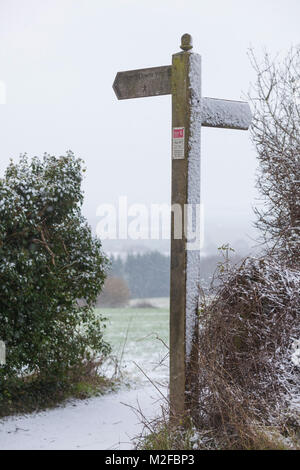 Charing, Kent, UK. 7th Feb, 2018. UK Weather: Specks of snow fell this morning in this part of Kent, very near the Kent downs and the village of Charing. Pictured is a signpost for the north downs way covered in fresh snow. Photo Credit: PAL Images / Alamy Live News Stock Photo