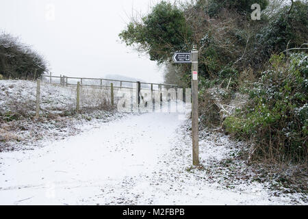 North downs way signpost covered in snow Stock Photo