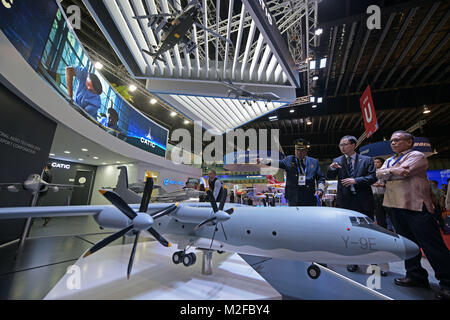 Singapore. 7th Feb, 2018. People visit China National Aero-Technology Import and Export Corporation (CATIC) exhibition booth during the Singapore Airshow in Changi Exhibition Centre in Singapore on Feb. 7, 2018. The biennial Singapore Airshow kicked off here on Tuesday and will last to Feb. 11. Credit: Then Chih Wey/Xinhua/Alamy Live News Stock Photo