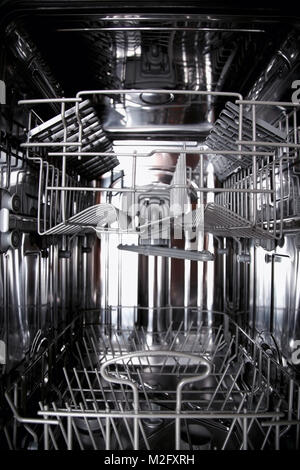 View of the interior of an empty opened dishwasher Stock Photo