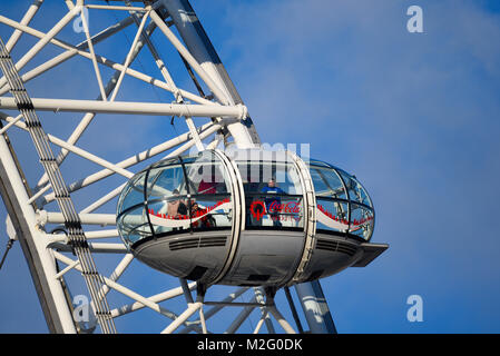 Pod of the Coca Cola London Eye Millennium Wheel in blue sky. London tourist attraction with tourists in capsule Stock Photo