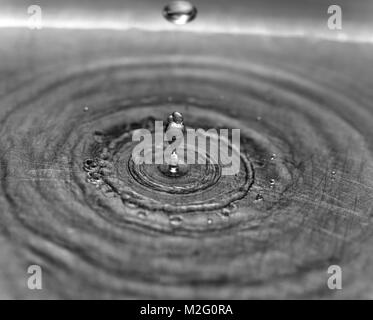 water droplets dropping into a stainless steel sink Stock Photo