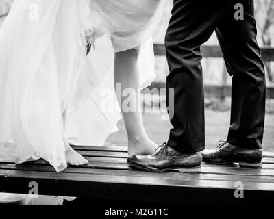 bride and groom show their shoes Stock Photo