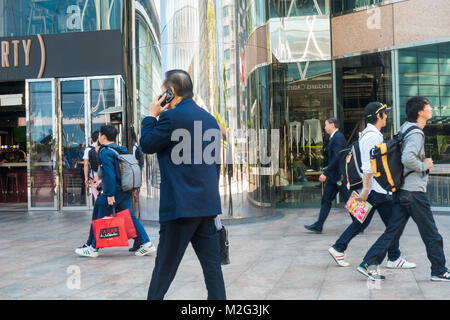 Hong Kong Man on smartphone Stock Photo