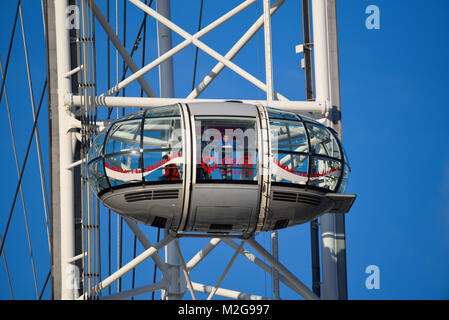 Pod of the Coca Cola London Eye Millennium Wheel in blue sky. London tourist attraction with tourists in capsule Stock Photo