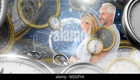 Aging couple in surreal time montage of clocks Stock Photo