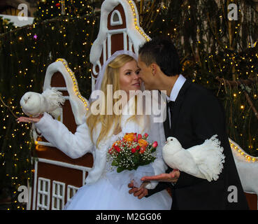 Prague, Czech Republic - unknown newly weds celebrate their marriage in the Christmas Market on Old Town Square in the city, image in landscape format Stock Photo