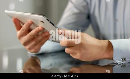 Businessman working on tablet PC, using mobile app, technology in business HD Stock Photo