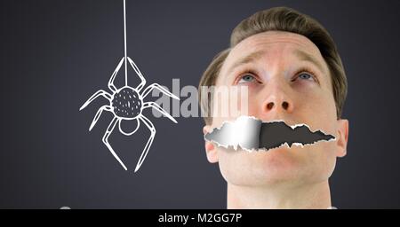 Arachnophobia fear Man with torn paper on mouth and scary spider drawing Stock Photo