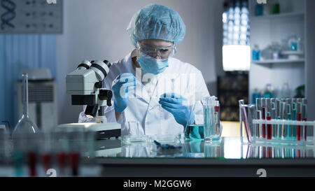 Sample Lab Dripper Laboratory worker dripping sample into test tube, double exposure with ...