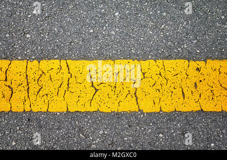 Close up picture of an asphalt road with yellow lane. Stock Photo