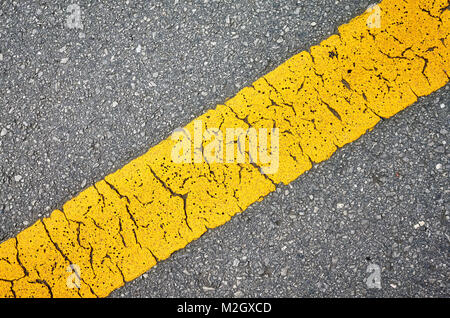Close up picture of an asphalt road with yellow lane. Stock Photo