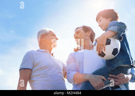 Three generations of men spending time outdoors Stock Photo