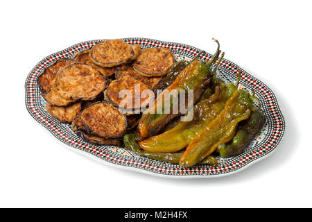 Moroccan dish with baked eggplants and green bell peppers isolated on white background Stock Photo