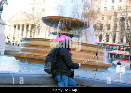 Tourist taking a selfie in Trafalgar Square, London Stock Photo