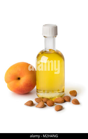 Apricot kernel oil and apricot kernels isolated on the white background ...