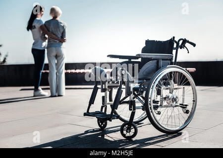 Selective focus of a wheelchair standing on the ground Stock Photo