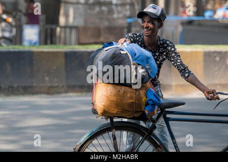 Mumbai, India - January 21,2018: Young Boy with Bicycle and Goods  Laughing at Friend near   Mumbai CSMT, Maharashtra India Stock Photo