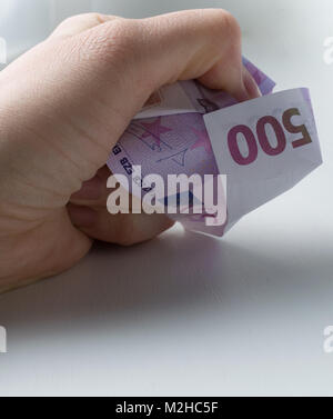 Closeup crumpled banknote of 500 euros isolated on white background ...