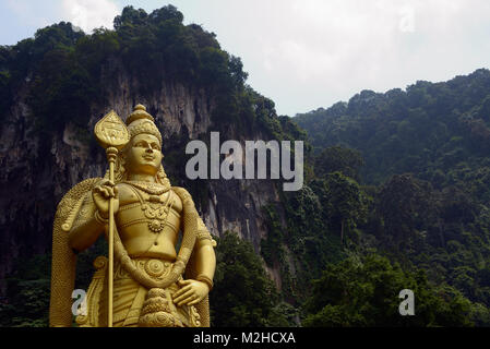 Kuala Lumpur, Malaysia - November 3, 2014:  42-meter statue of Lord Murugan that stands next to the stairs, leading to the top Batu Caves, located in  Stock Photo